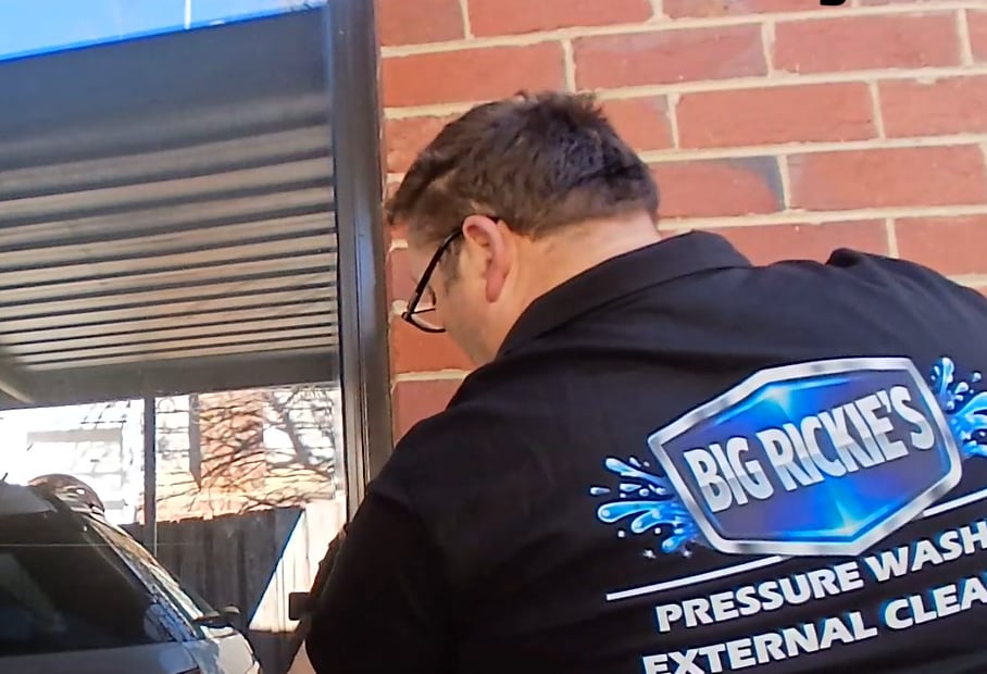 Big Rickie on the job in his Big Rickie's Pressure Washing shirt