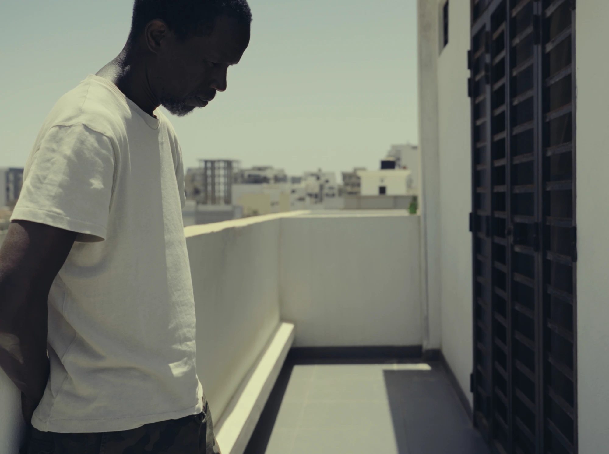 Daouda on balcony overlooking Dakar