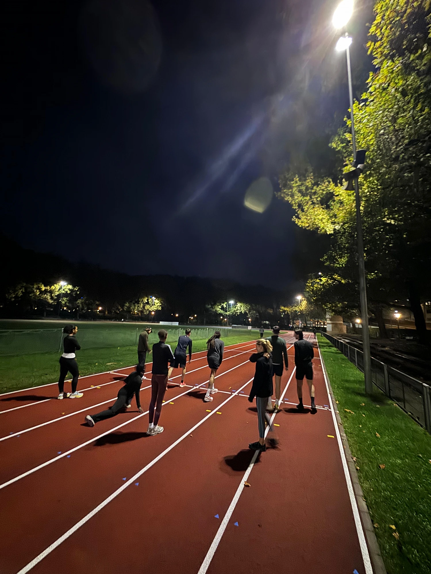 Athletes on track at sunset