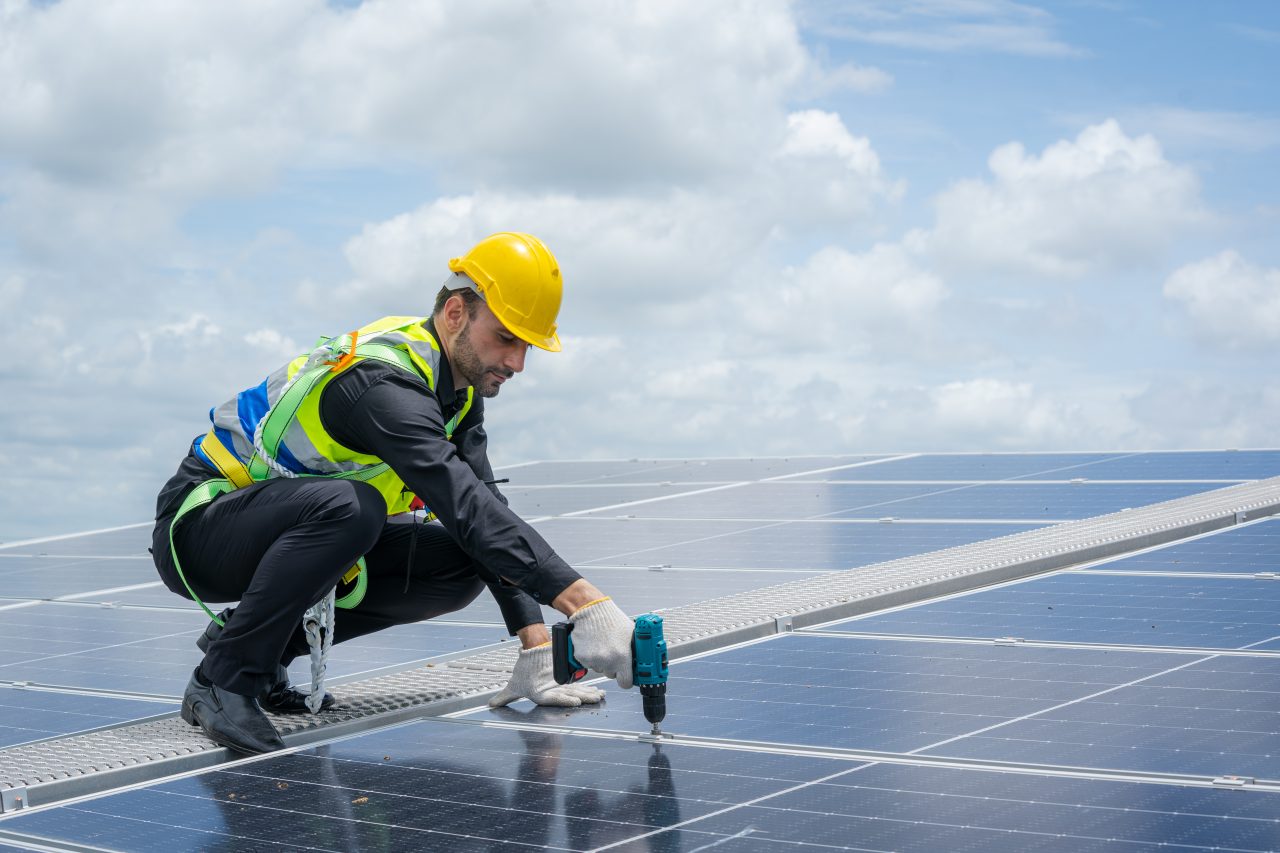Solar technician installing a rooftop solar system
