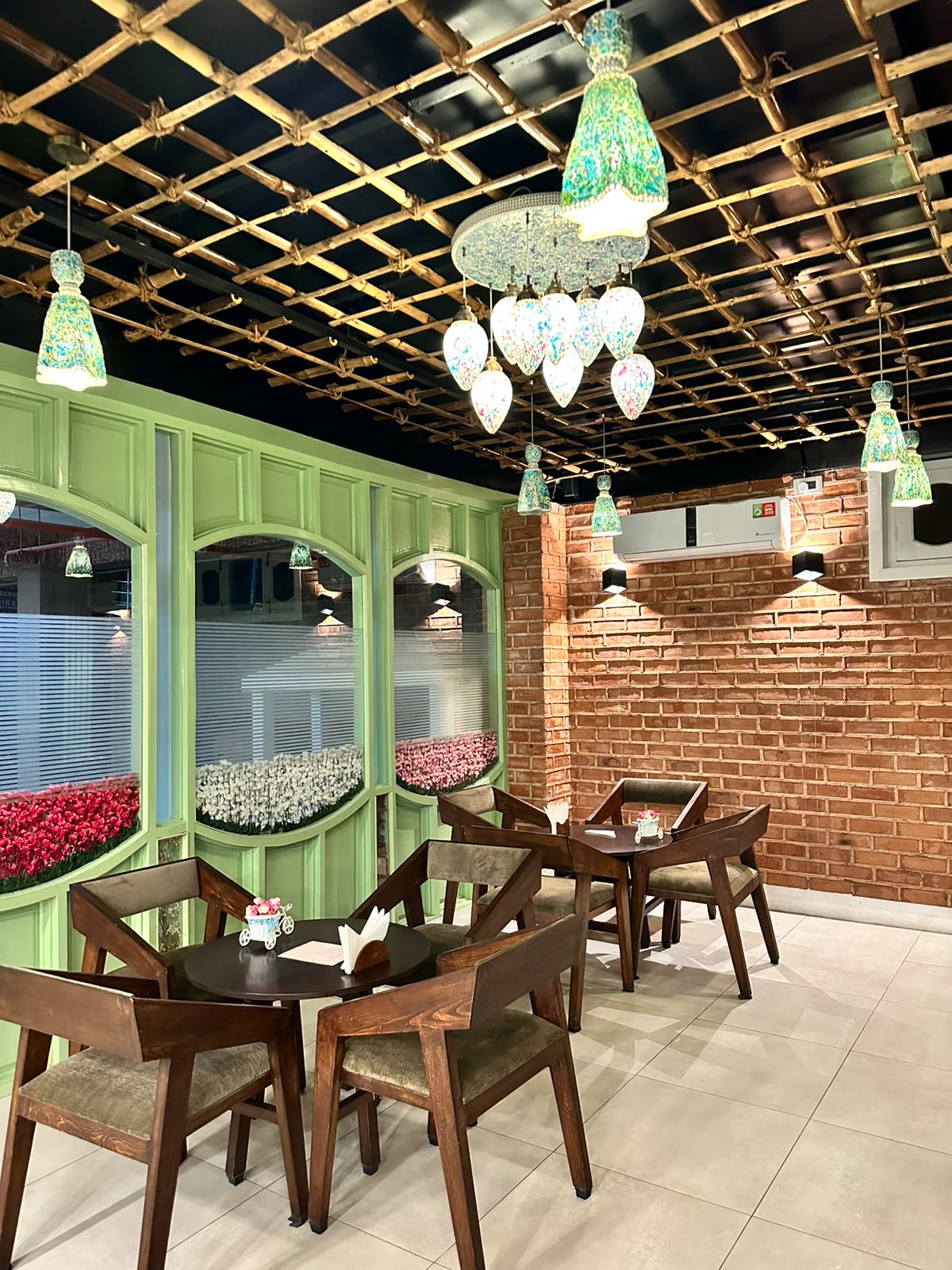 The dining room — sage panels under lantern light.
