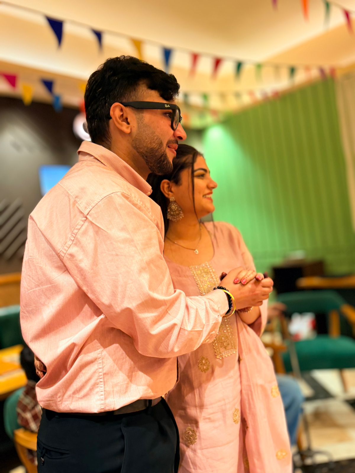 Sarthak and Tanishka in matching pink outfits amid festive decor