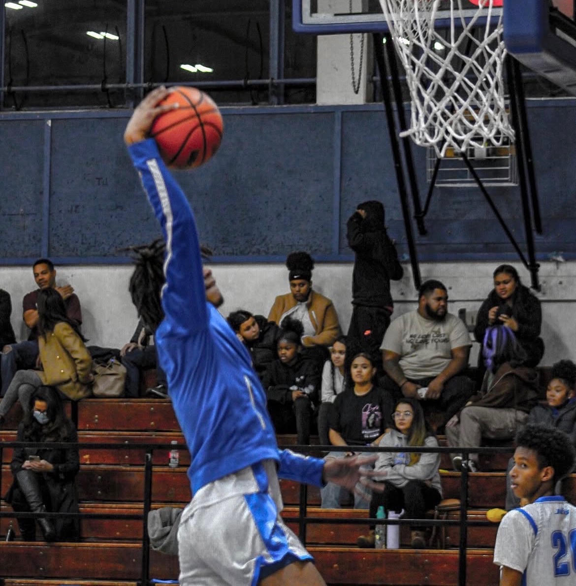 Player dunking during a game with the crowd watching