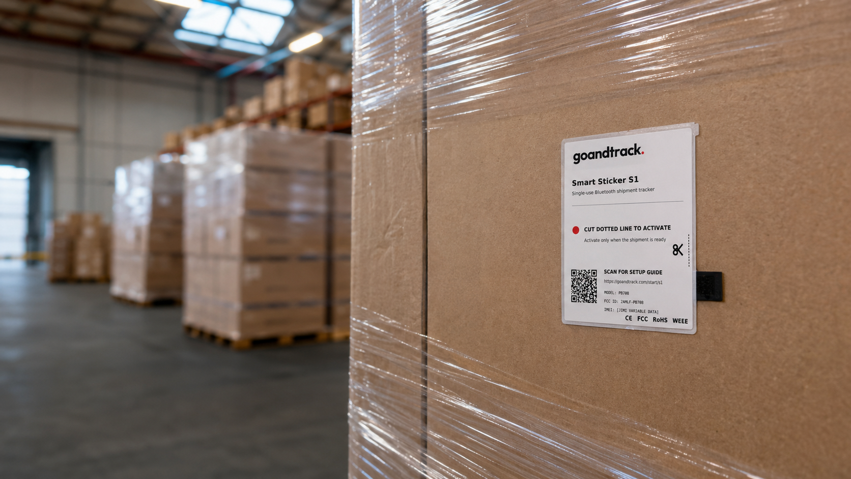GNTS1 Smart Sticker S1 applied to a shrink-wrapped pallet in a warehouse aisle
