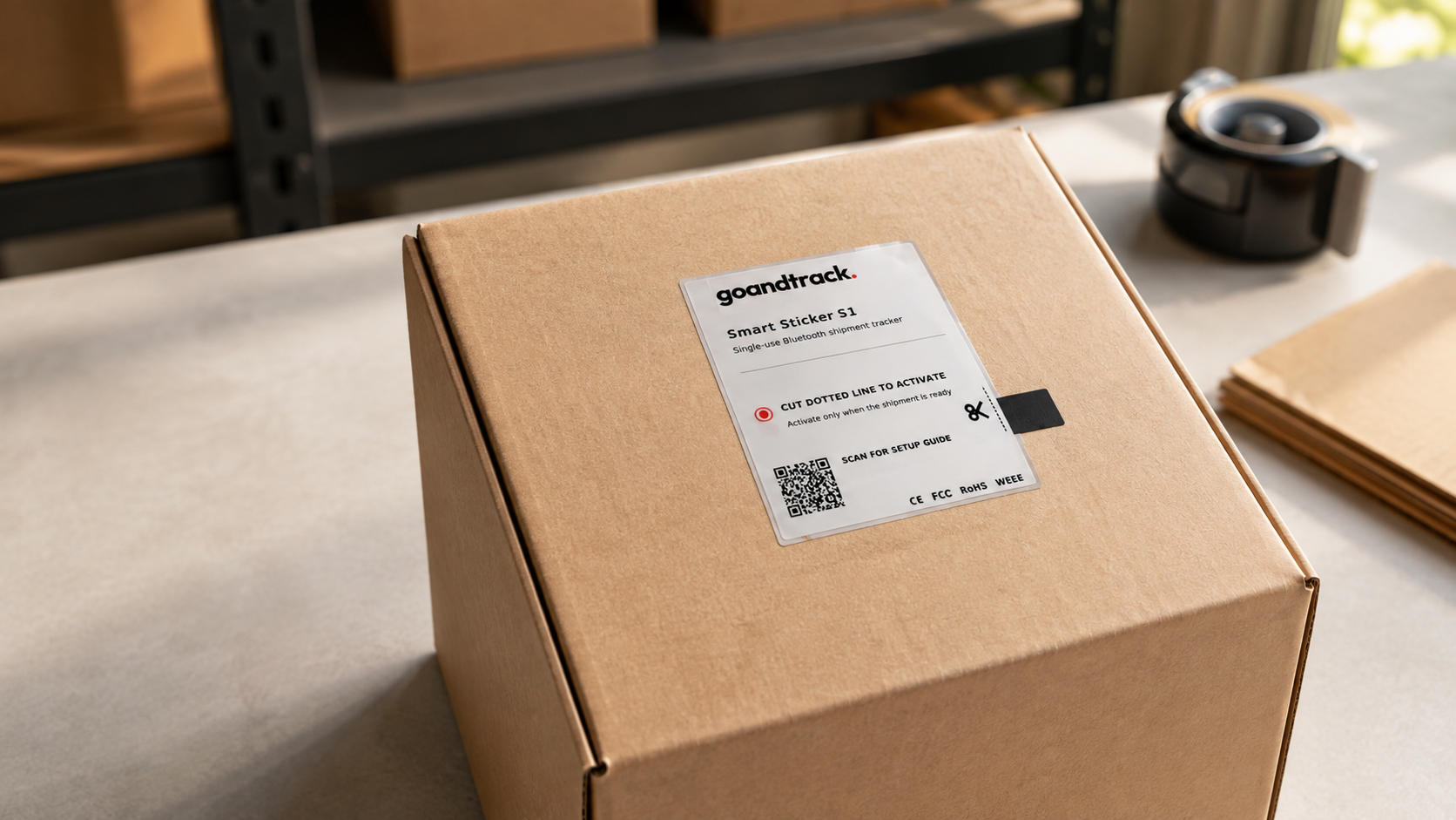GNTS1 Smart Sticker S1 applied to a cardboard parcel on a packing bench