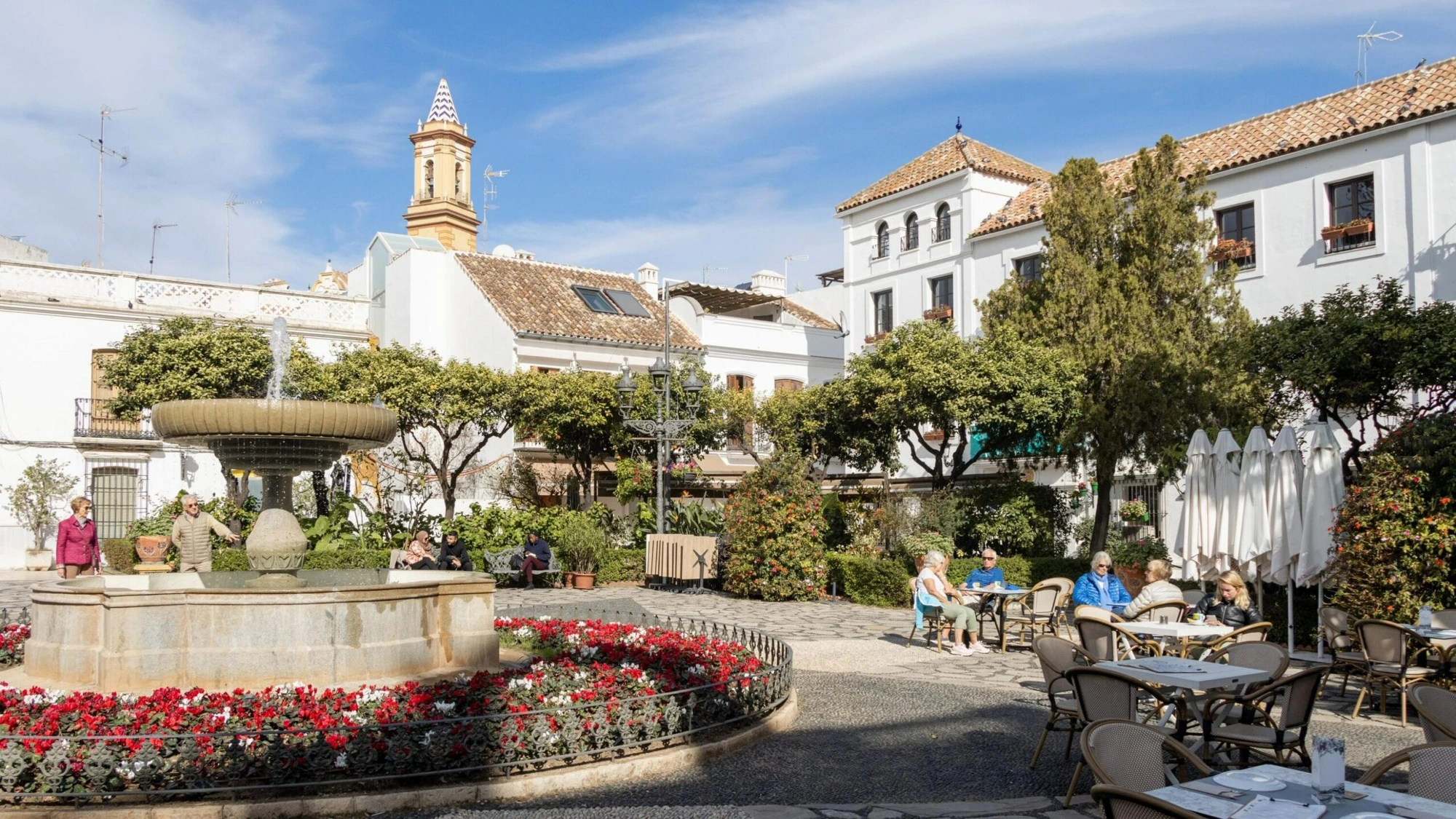 Sunny Andalusian plaza with fountain and cafes