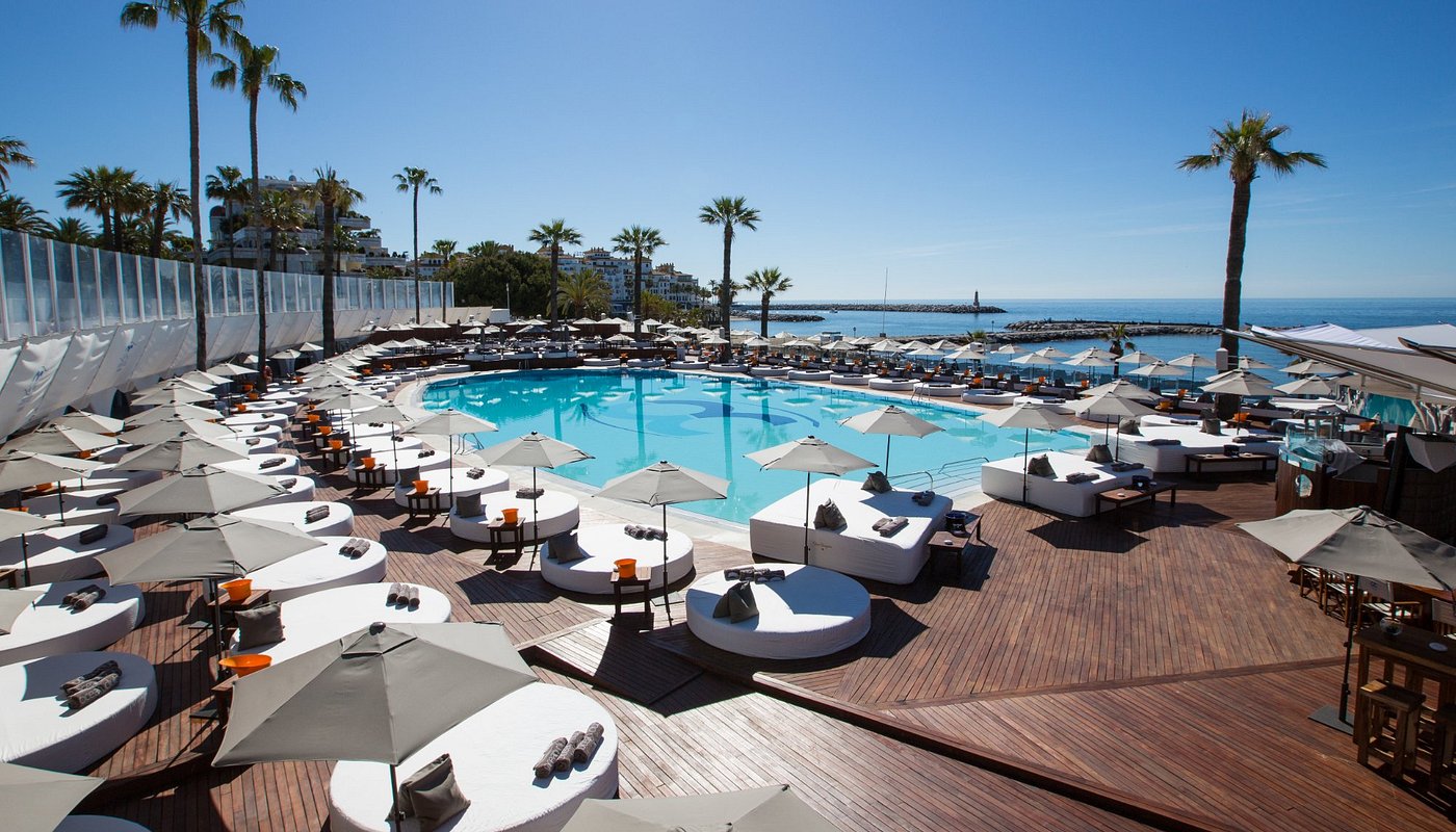 Ocean Club Marbella pool deck with white daybeds