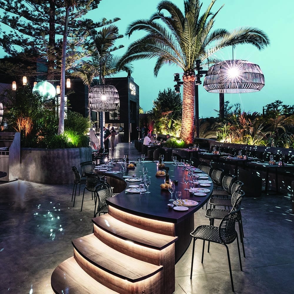 Evening dining terrace under palm trees in Marbella