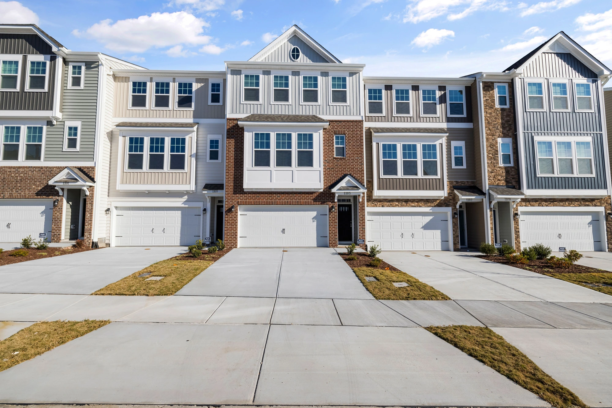 Row of BC townhomes with private entrances and garages — Lower Mainland townhouse and half-duplex expertise from Doug LeMaire