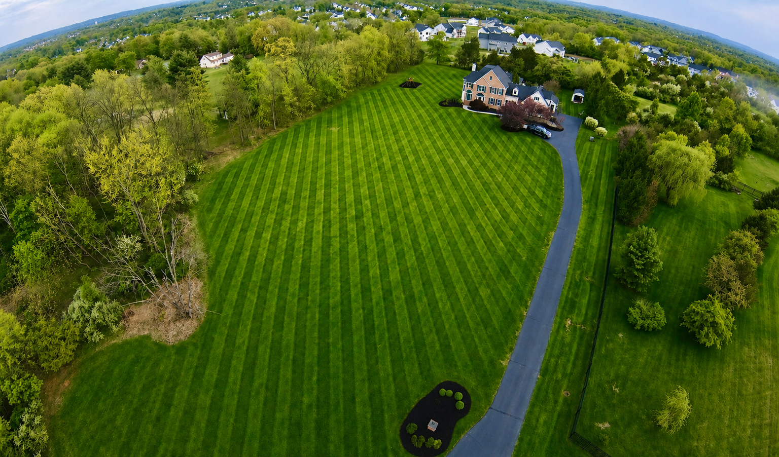 Aerial view of a striped lawn maintained by Rapid Response
