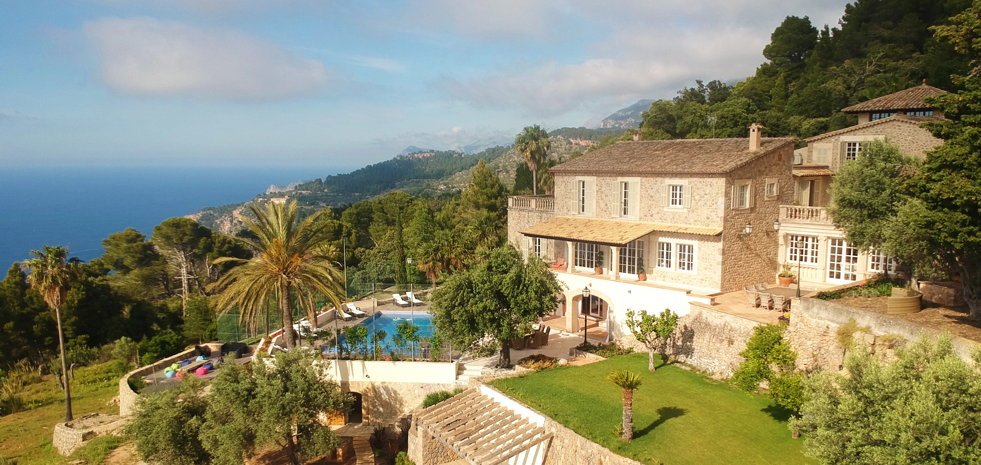 Aerial view of a Mallorcan finca with pool and sea beyond